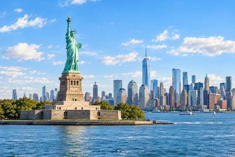 Statue of Liberty and the Manhattan skyline across New York harbour.